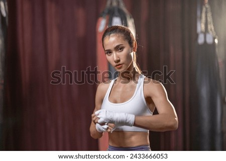 Portrait of a female boxing enthusiast in the ring, demonstrating consistent dedication and ability in a struggle for success, aspiring to become a professional athlete.