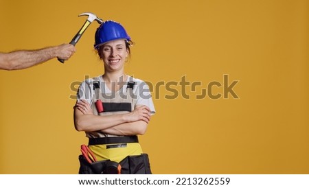 Portrait of female builder being hit in head and feeling dizzy, seeing stars in eyes and acting disorientated or light headed. Unsteady shaky woman feeling weak and wobbly, looney tunes.