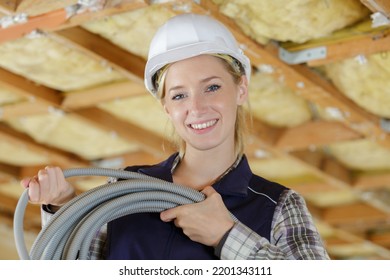 Portrait Of Female Builder Holding Cable Conduit