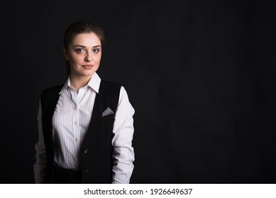 Portrait Of A Female Business Lady In The Studio On A Black Background With Copyspace