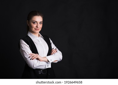 Portrait Of A Female Business Lady Who Crossed Her Arms In The Studio On A Black Background With Copyspace