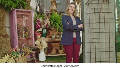 Portrait Of Female Business Owner Of Local Flower Shop Standing In Storefront Smiling At Camera With Arms Crossed. Happy Entrepreneur Of Local Small Business Flower Store