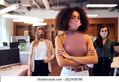 Portrait Of Female Business Team Wearing Face Masks In Open Plan Office During Covid-19 Pandemic