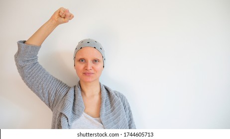 Portrait of female cancer survivor without eyebrows. Happy cancer survivor after successful chemotherapy.  Female hairless fight against cancer no white background. Negative space. Copy space for text - Shutterstock ID 1744605713