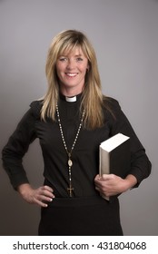 Portrait Of A Female Clergy Wearing A Black Shirt And Dog Collar