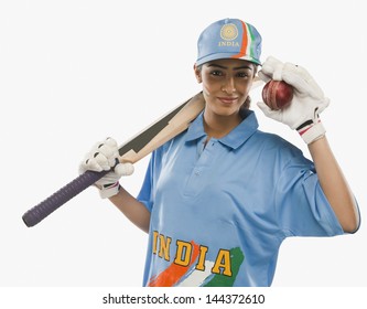 Portrait of a female cricketer holding a cricket bat and a ball - Powered by Shutterstock