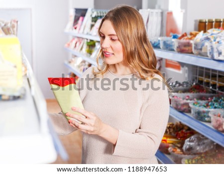 Portrait of  female customer choosing spices in  grocery food shop