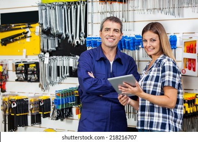 Portrait Of Female Customer And Male Vendor With Digital Tablet In Hardware Store