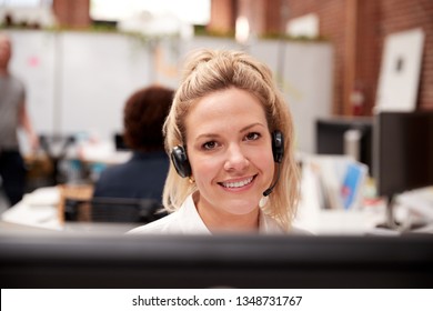 Portrait von weiblichen Kundendienstmitarbeitern, die am Arbeitsplatz im Call Center arbeiten