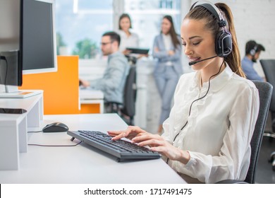 Portrait Of Female Customer Support Or Sales Agent. Caller Or Receptionist Phone Operator Working In Call Center.