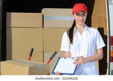 Portrait Of Female Delivery Driver With Clipboard And Box