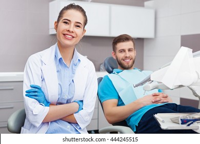 Portrait Of A Female Dentist And Young Happy  Male Patient In A Dentist Office.