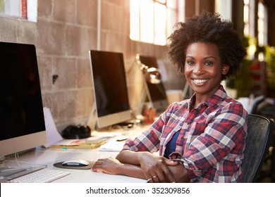 Portrait Of Female Designer Working At Desk In Modern Office