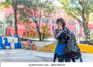 Portrait Of Female Diver Cleaning Her Equipment After A Diving Class