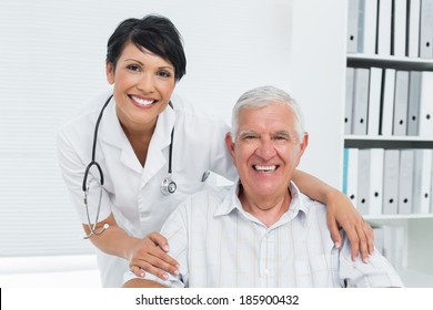 Portrait Of A Female Doctor With Happy Senior Patient At The Hospital