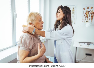 Portrait of a female doctor helping a senior woman at office with her neck injury and putting her collar a healthcare and medicine concepts. Doctor putting a neck brace on a senior patient  - Powered by Shutterstock