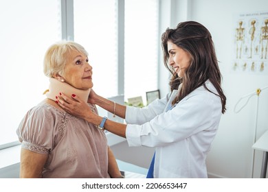 Portrait Of A Female Doctor Helping A Senior Woman At Office With Her Neck Injury A Healthcare And Medicine Concepts. Doctor Putting Neck Orthopaedic Collar On Adult Injured Woman