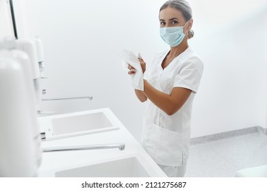  Portrait Of Female Doctor Or Nurse Drying Hands With Paper Tissue At Hospital After Washing Hands. Hygiene, Health Care.