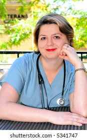 Portrait Of A Female Doctor Or Nurse Taking A Break In Outside Cafe