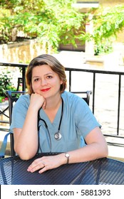 Portrait Of A Female Doctor Or Nurse Taking A Break In Outside Cafe