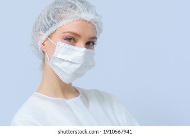 Portrait Of A Female Doctor Or Nurse Wearing Medical Cap And Face Mask