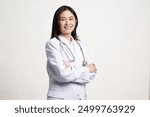 Portrait female doctor wearing medical uniform and stethoscope at hospital.Beautiful smiling young asian woman doctor isolated on white background.Doctor arms crossed wear white coat and stethoscope.