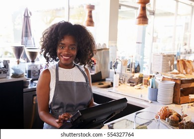 Portrait Of Female Employee Working At Delicatessen Checkout