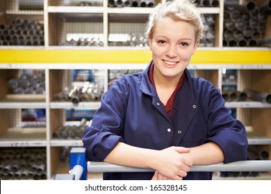 Portrait Of Female Engineering Apprentice In Store Room