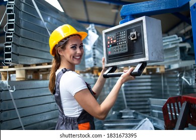 Portrait of female factory worker operating industrial machine and setting parameters on the computer. - Powered by Shutterstock