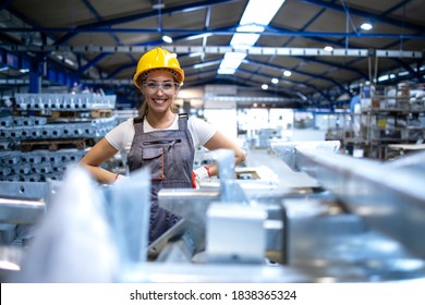 Portrait of female factory worker standing in production hall. - Powered by Shutterstock