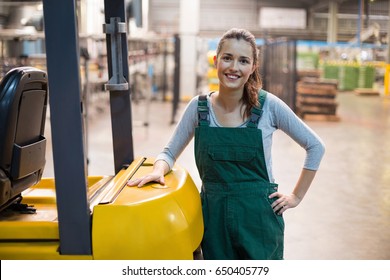 Portrait Of Female Factory Worker Standing At Drinks Production Factory