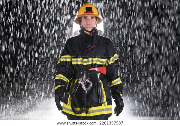 Portrait of a female firefighter standing and\
walking brave and\
optimistic.