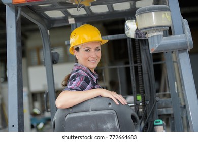 Portrait Of Female Fork Lift Truck Driver In Factory