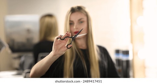 Portrait of female hairdresser holding scissors in hand, master ready to change client image. Beauty studio, self care and wellness concept - Powered by Shutterstock