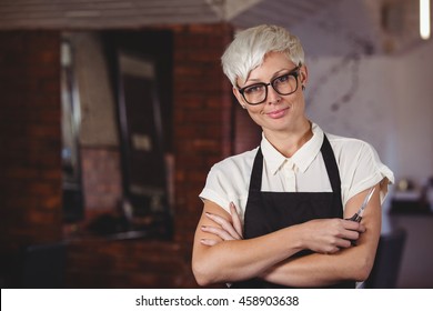 Portrait Of Female Hairdresser Standing With Arm Crossed At A Salon