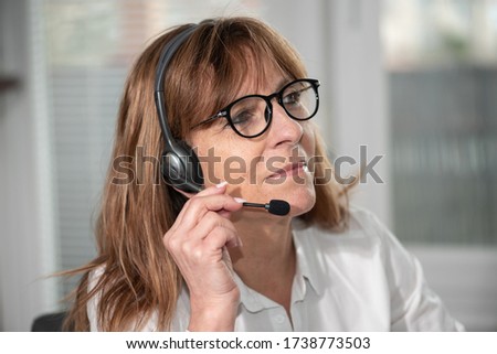 Portrait of female helpline operator in headset