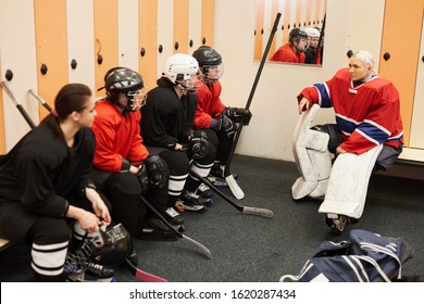 Portrait Of Female Hockey Team Captain Giving Motivational Pep Talk In Locker Room Before Match, Copy Space