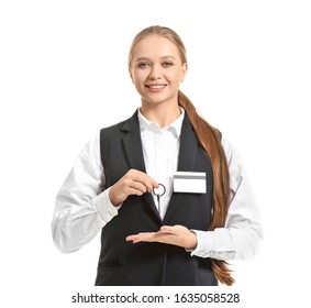 Portrait Of Female Hotel Receptionist With Room Key On White Background