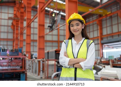Portrait of Female Industrial Worker Standing with Arm Crossed in the Factory - Shutterstock ID 2144910713