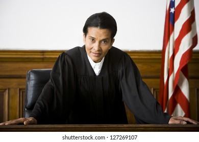 Portrait Of A Female Judge Leaning Against A Bench