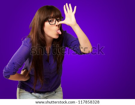 Portrait Of A Female Making Funny Face On Blue Background