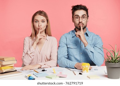 Portrait Of Female And Male Office Workers Or Students Show Silence Sign Ask To Be Quiet As There Is Meeting In Next Room, Works With Papers And Documments, Prepare Business Report Together.