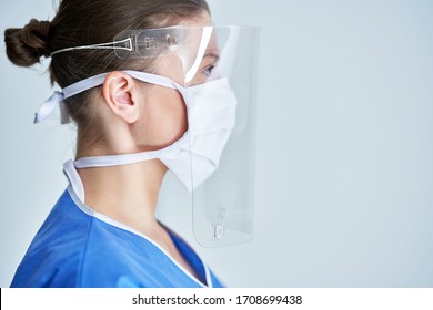 Portrait Of Female Medical Doctor Wearing Protective Mask And Face Shield