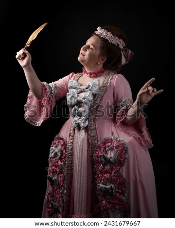 portrait of female model wearing an opulent pink gown,  costume of a historical French baroque nobility, style of Marie Antoinette. Holding feather quill. isolated silhouette on dark background