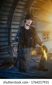 Portrait Of Female Modern Army Special Forces Soldier, Anti Terrorist Squad Fighter, Elite Commando Warrior Using Four-eyed Night Vision Goggles In Dark Background