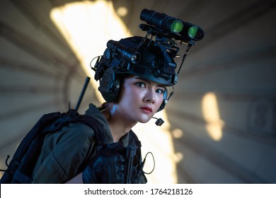 Portrait Of Female Modern Army Special Forces Soldier, Anti Terrorist Squad Fighter, Elite Commando Warrior Using Four-eyed Night Vision Goggles In Dark Background