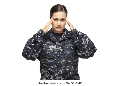 Portrait Of Female Navy Sailor With Head In Hands Against White Background