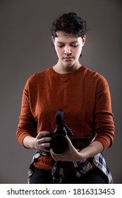 Portrait Of A Female Online Content Creator Holding A Video Camera Used For Vlogging.  She Is An Amateur Filmmaker Or An Art Student