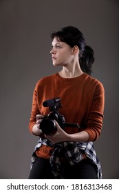 Portrait Of A Female Online Content Creator Holding A Video Camera Used For Vlogging.  She Is An Amateur Filmmaker Or An Art Student