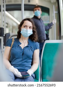 Portrait Of Female Passenger In Personal Protective Equipment Traveling In Tram